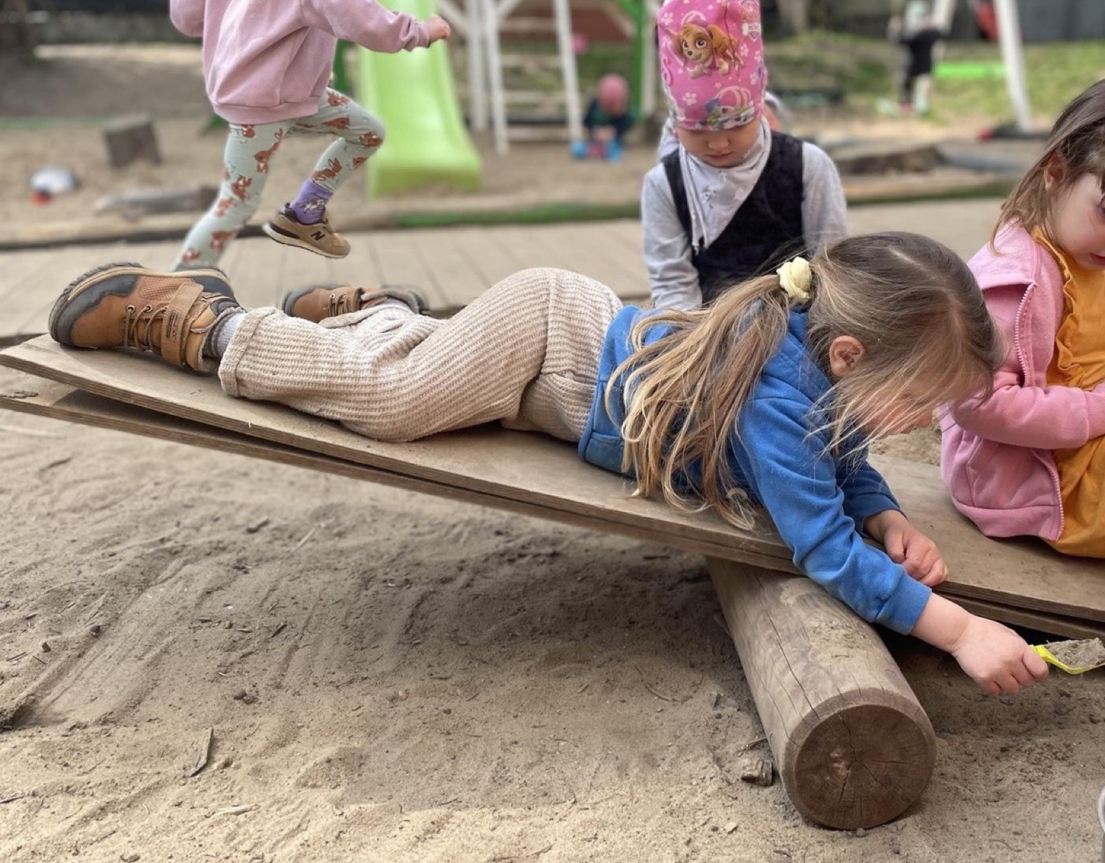 Children play in the sandbox in the garden